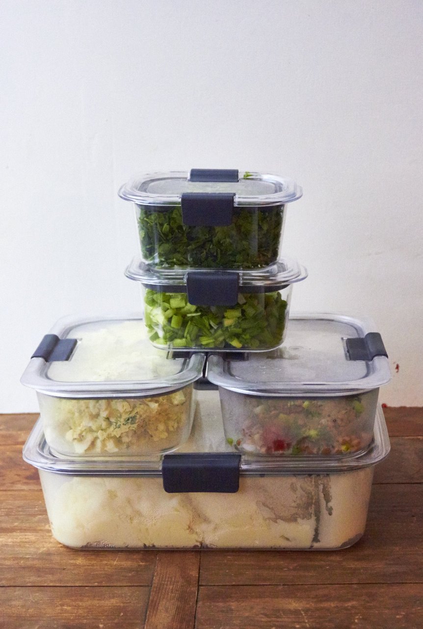 Five food storage containers in a stack.