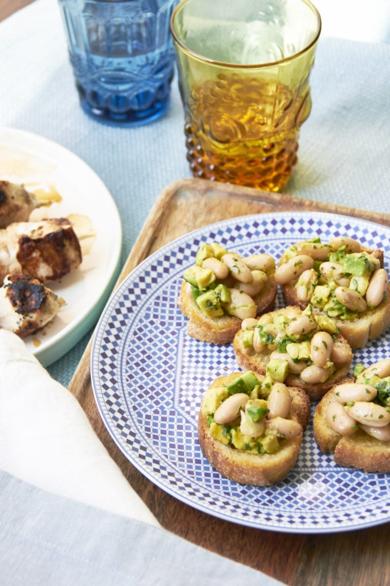 Plate of Avocado And Cannellini Bean Crostini With Gremolata.