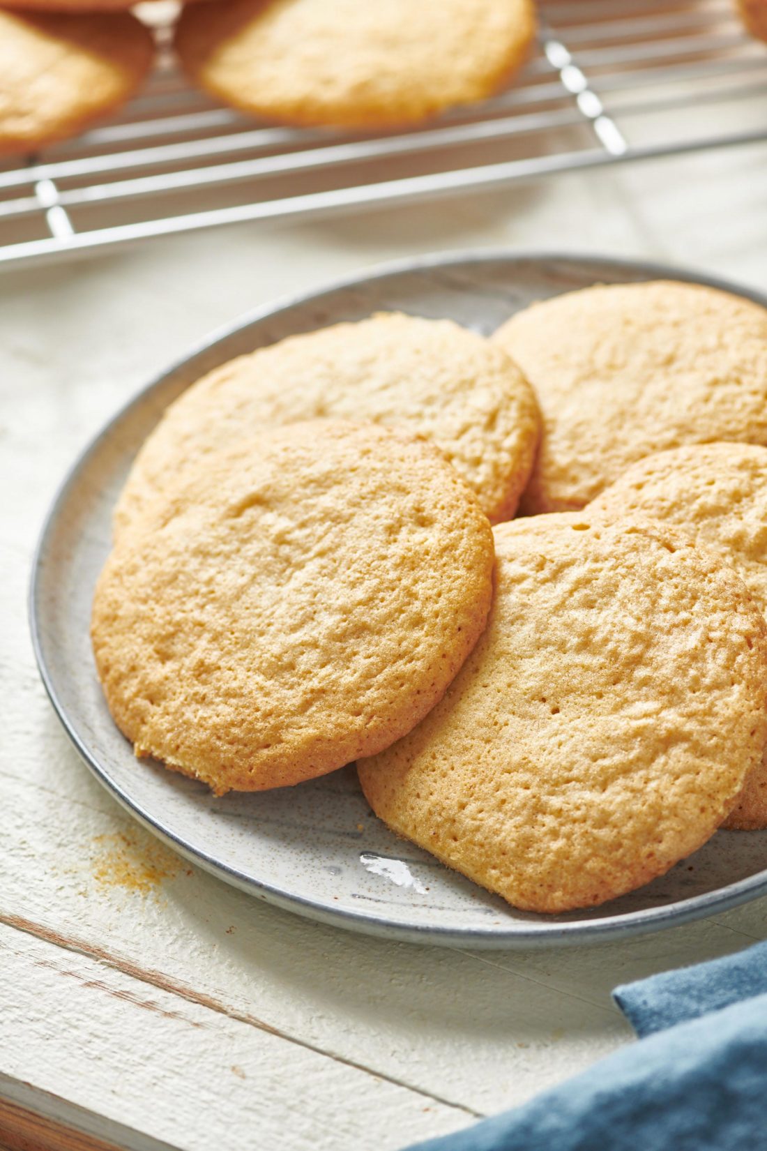 Soft Chewy Sugar Cookies leaning against each other on a plate.