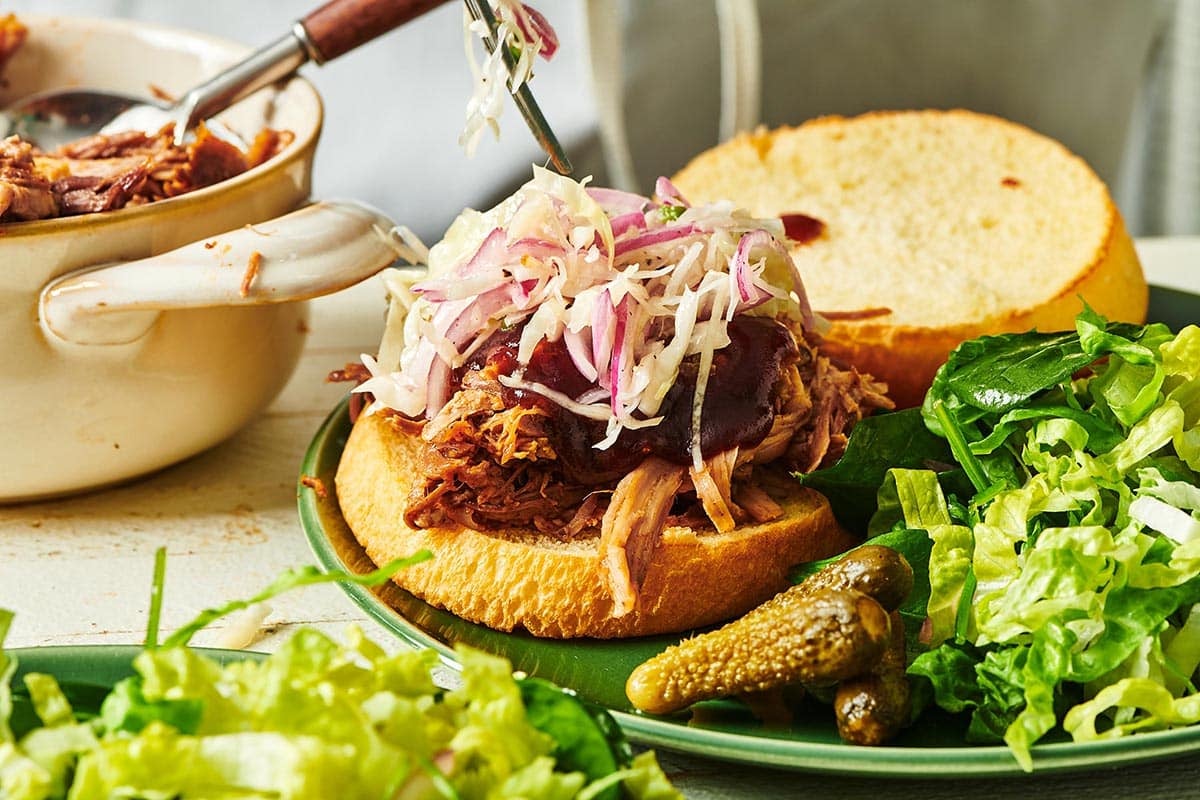 Pulled pork sandwich with barbeque sauce and coleslaw.