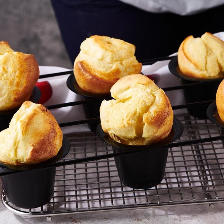 Wire rack with popovers in popover tins.