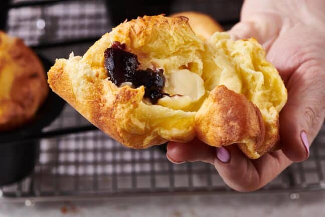 Popover topped with jelly and butter.