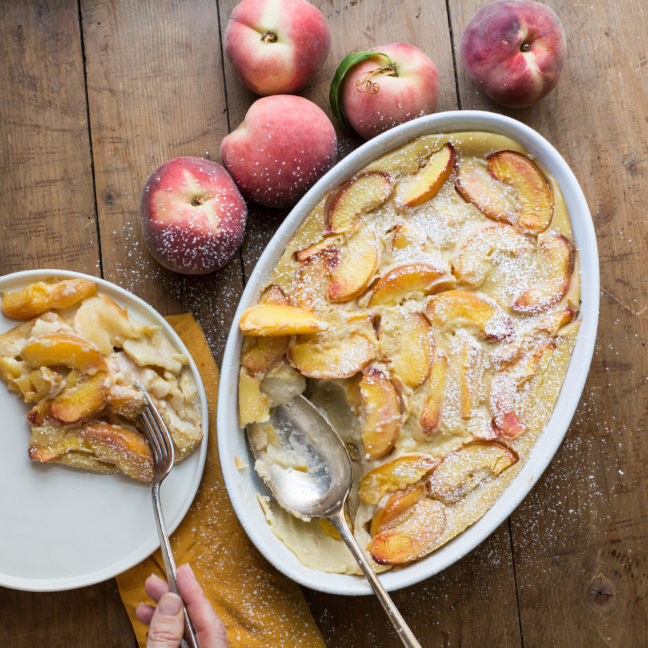 Serving dish and a plate of Peach Clafoutis.