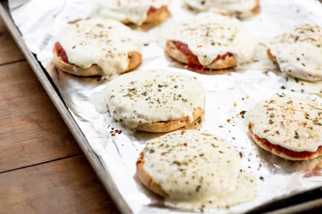 English Muffin Pizzas on a foil-lined baking sheet.