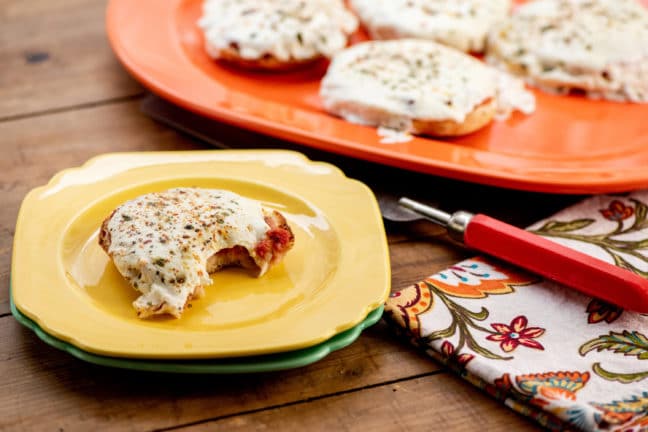 Brightly colored dishes with English Muffin Pizzas.