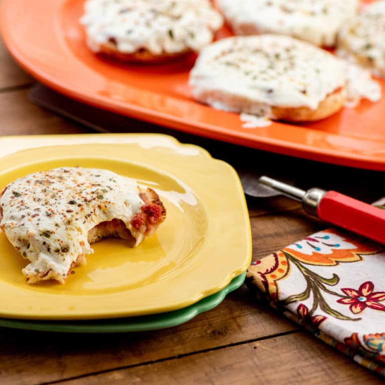 Brightly colored dishes with English Muffin Pizzas.
