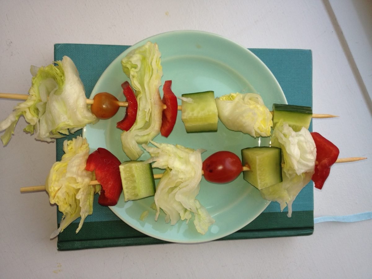 Salad Skewers on a blue plate.