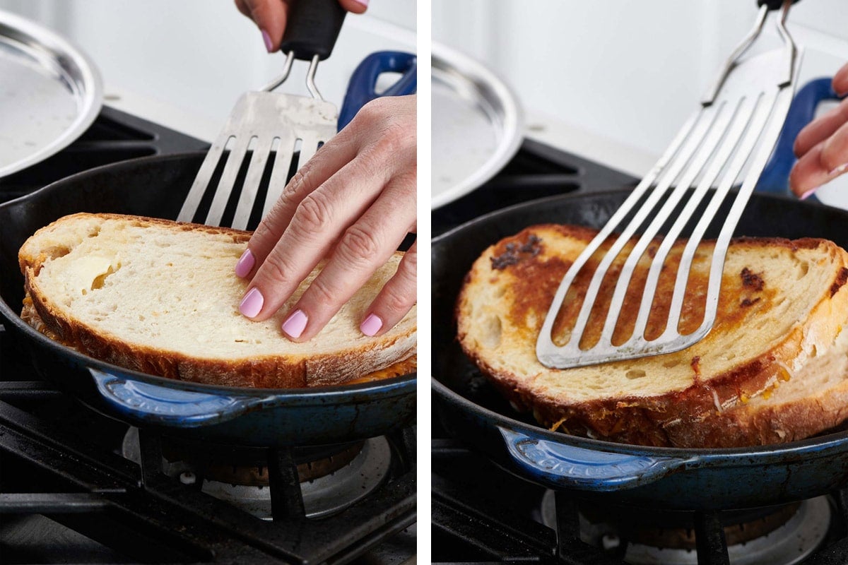 Woman flipping grilled cheese sandwich with spatula.