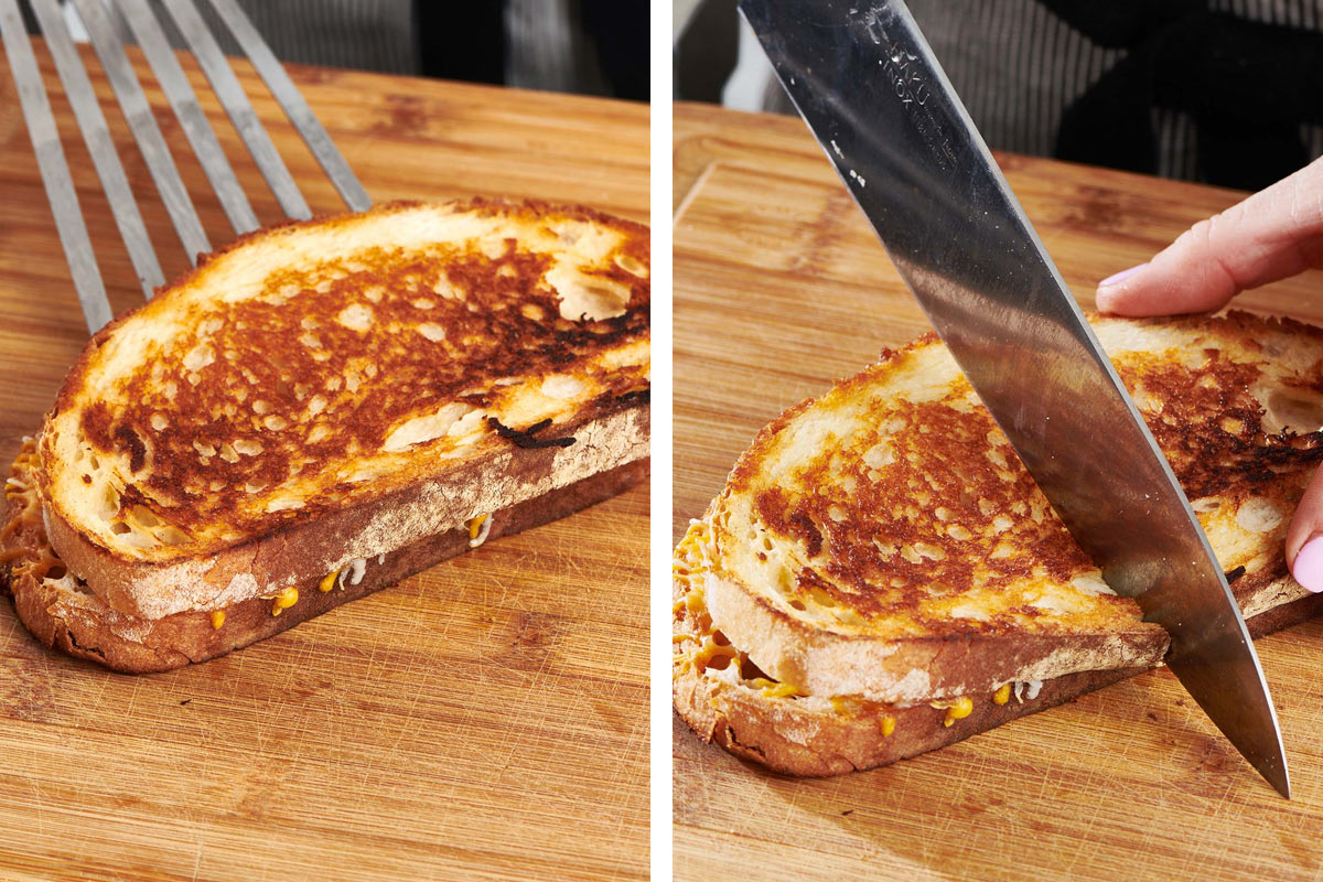 Cutting grilled cheese sandwich on with knife.