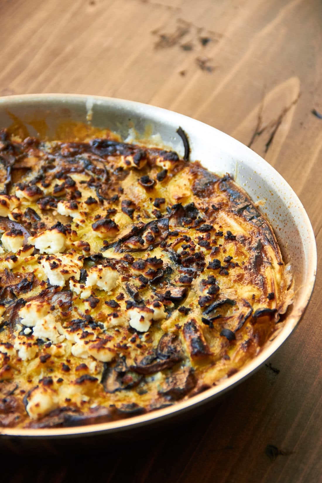 Mushroom, Caramelized Onion and Feta Frittata in a pan.