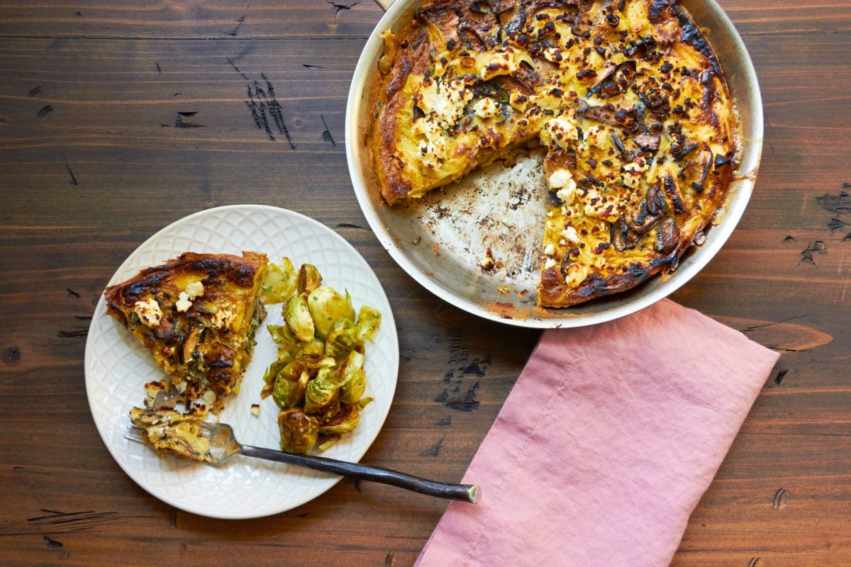 Mushroom, Caramelized Onion and Feta Frittata in a pan and on a plate.
