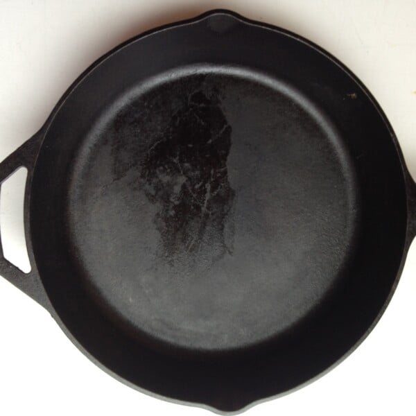 Cast iron skillet on a white surface.