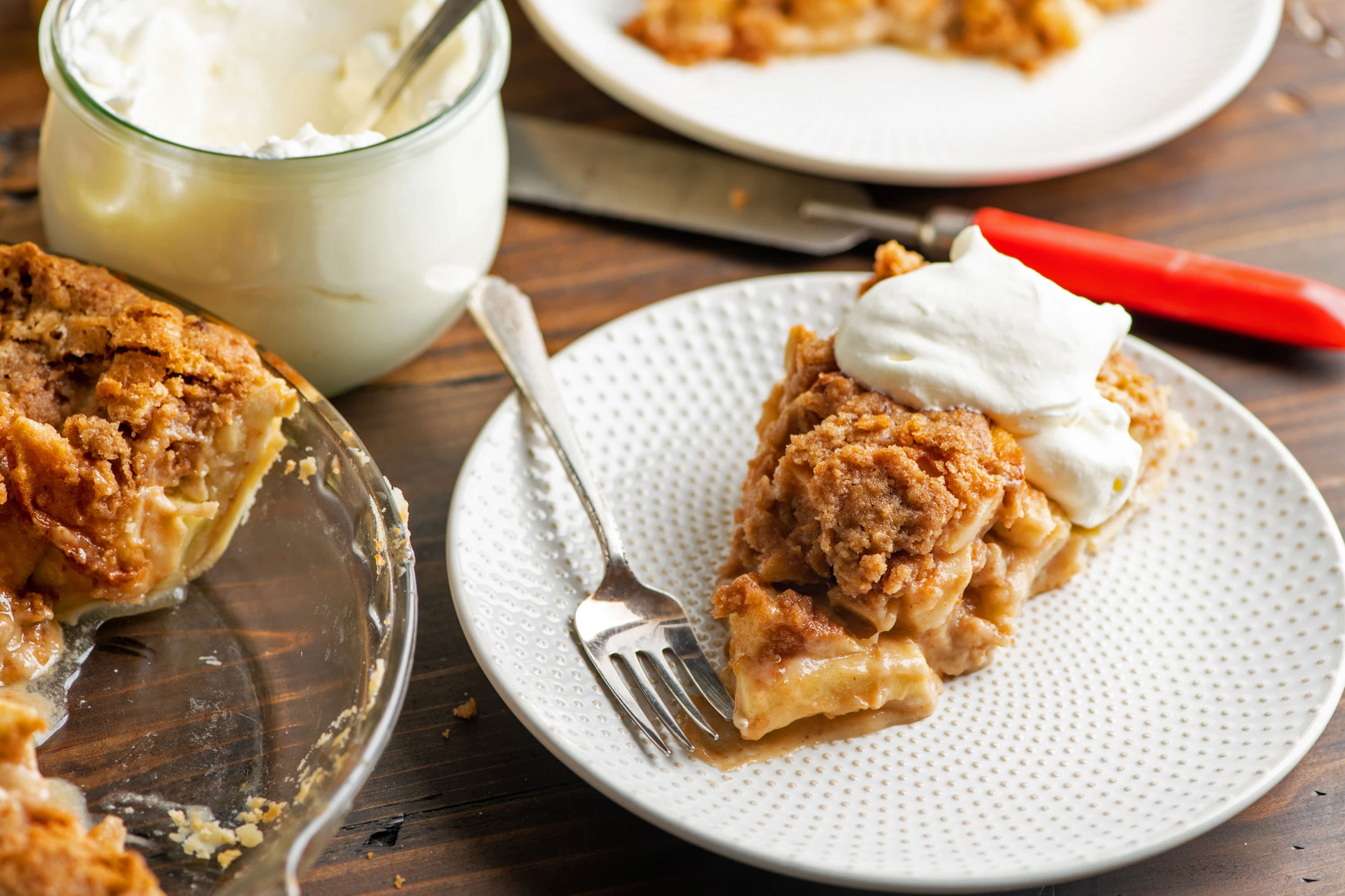 Slice of Streusel Apple Pie on a plate with a fork.