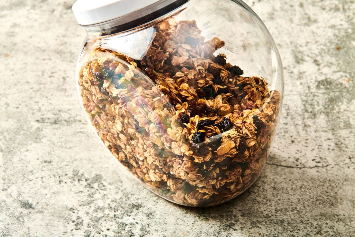 Granola in a see-through container with a lid.