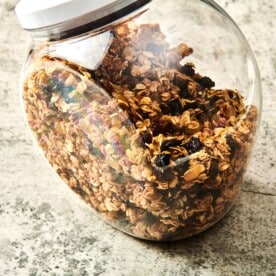 Granola in a see-through container with a lid.