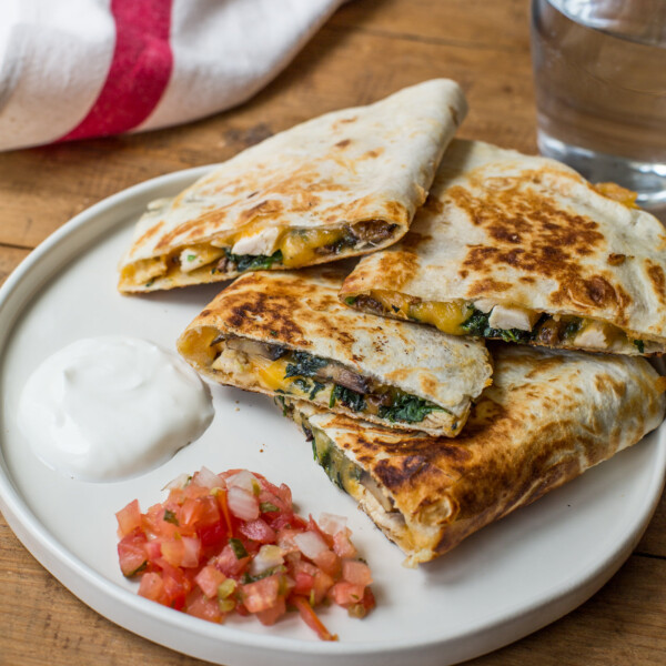 Quesadillas piled on a plate.