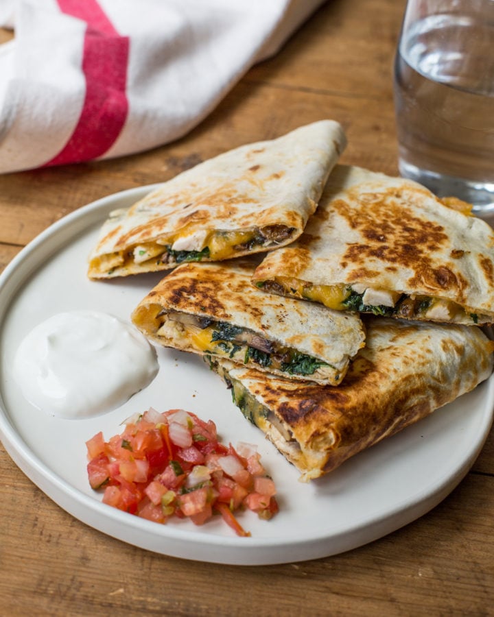 Quesadillas piled on a plate.