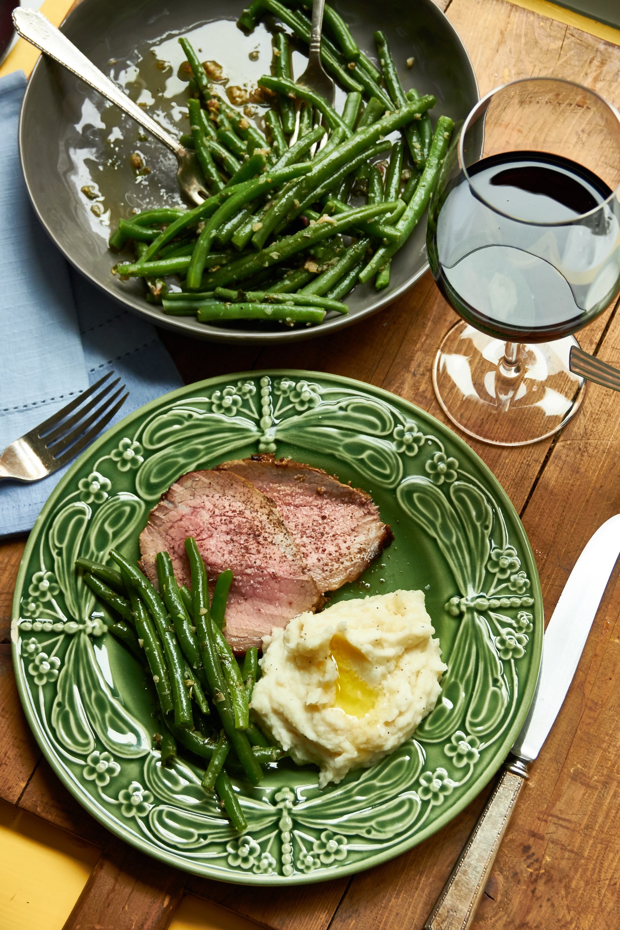Roast Beef with Mustard Garlic Crust, green beans, and mashed potatoes on a plate.