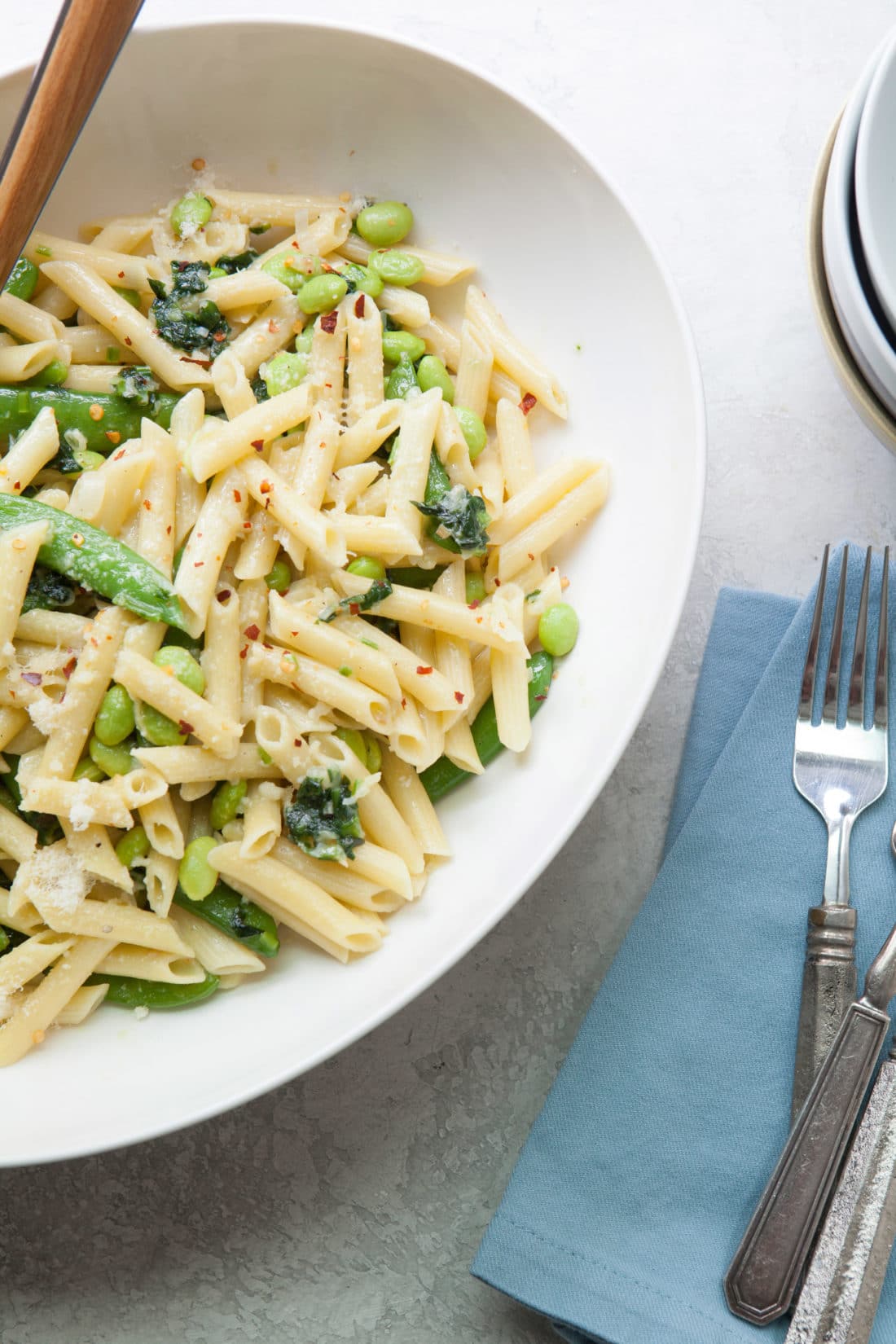 Bowl of Pasta with Ramps, Edamame, and Sugar Snap Peas in a Light Parmesan Cream Sauce.