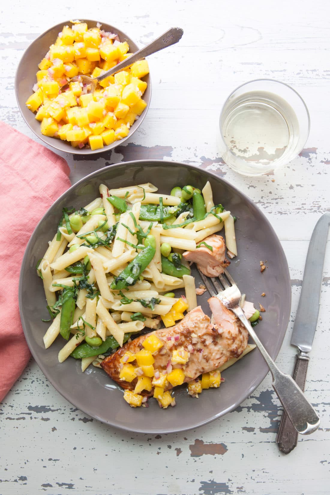 Plate of Pasta with Ramps, Edamame, and Peas in a Parmesan Cream Sauce next to fish.