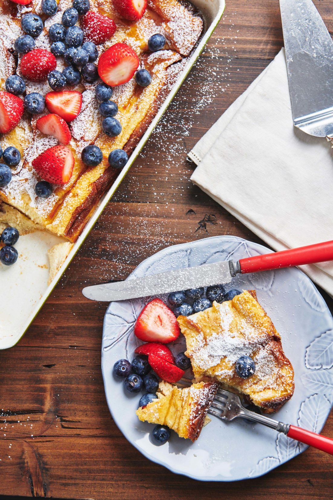 Berries and French Toast on a plate with a knife.