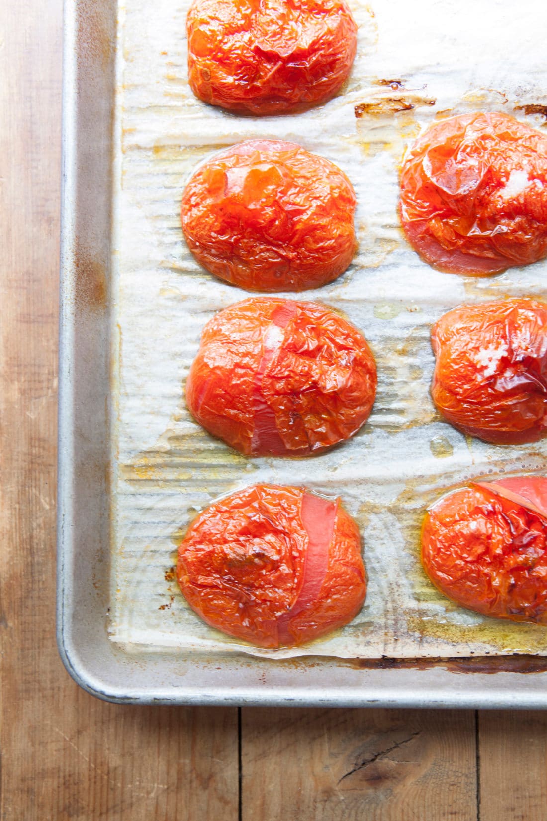 Roasted Tomatoes on a lined baking sheet.