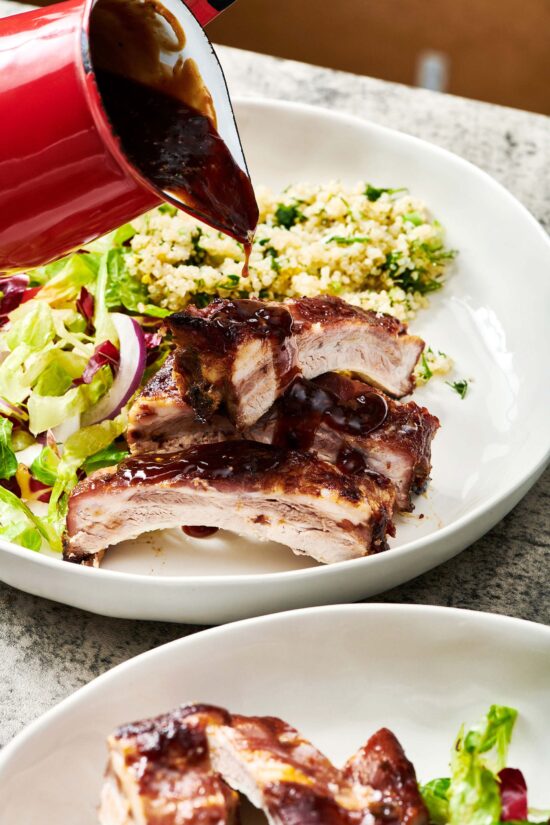 Asian Baby Back Ribs, salad, and grains on a plate.