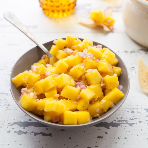 Spoon in a bowl of Citrusy Mango Ginger Salsa.