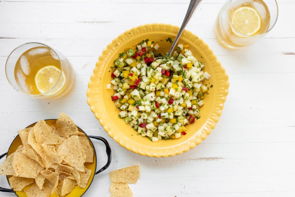 Bowls of Pineapple Mint Jalapeno Salsa and chips on a table.