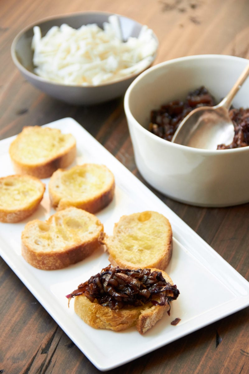 Sliced bread being topped with Radicchio and Endive mixture.