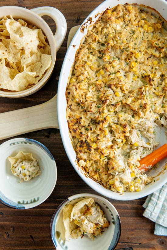 Hot Crab and Corn Dip with chips and carrots.