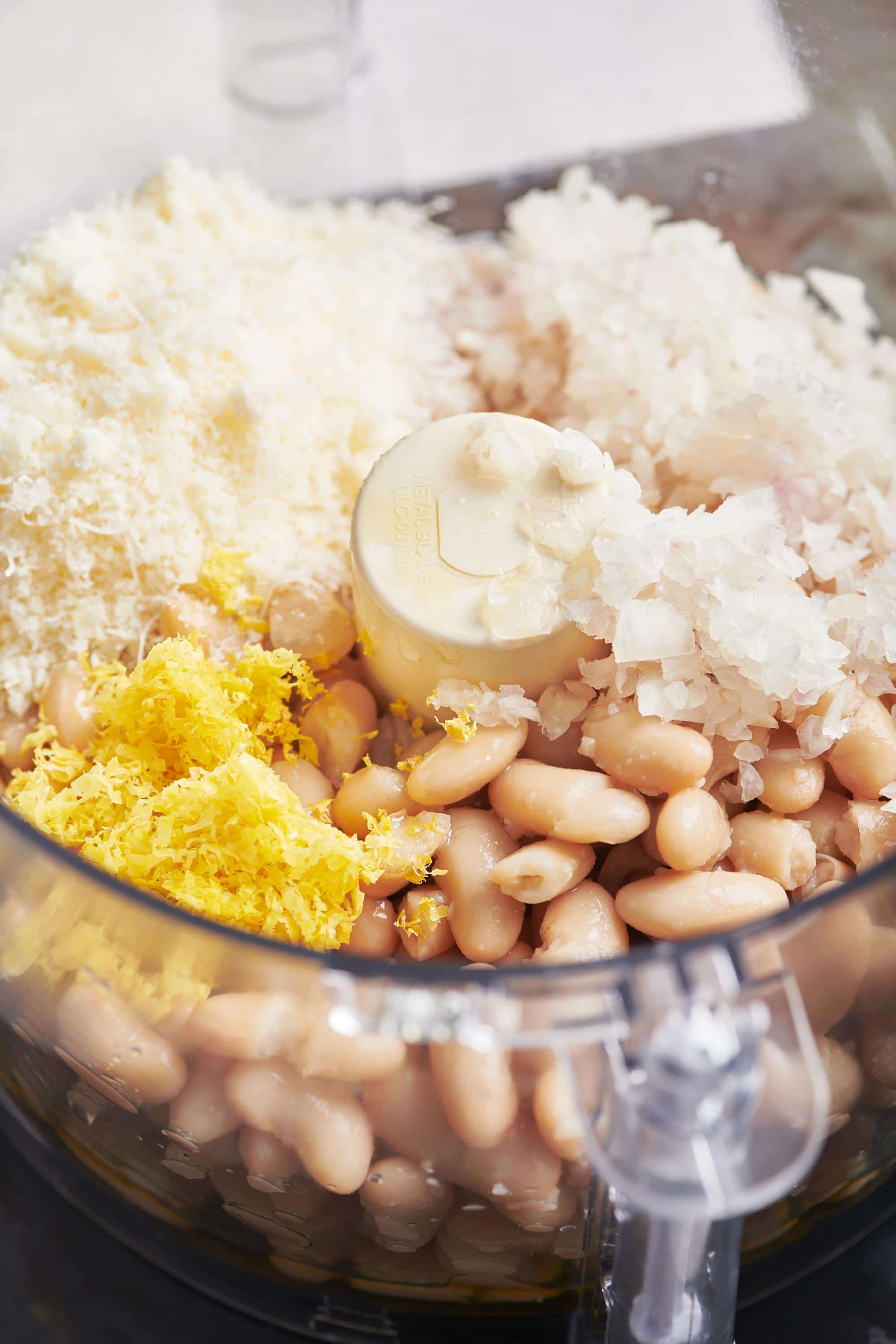 Cannellini beans, shallots, lemon zest, and parmesan in a food processor.