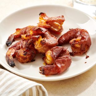 Five Prosciutto Wrapped Shrimp with Smoked Paprika on a plate.