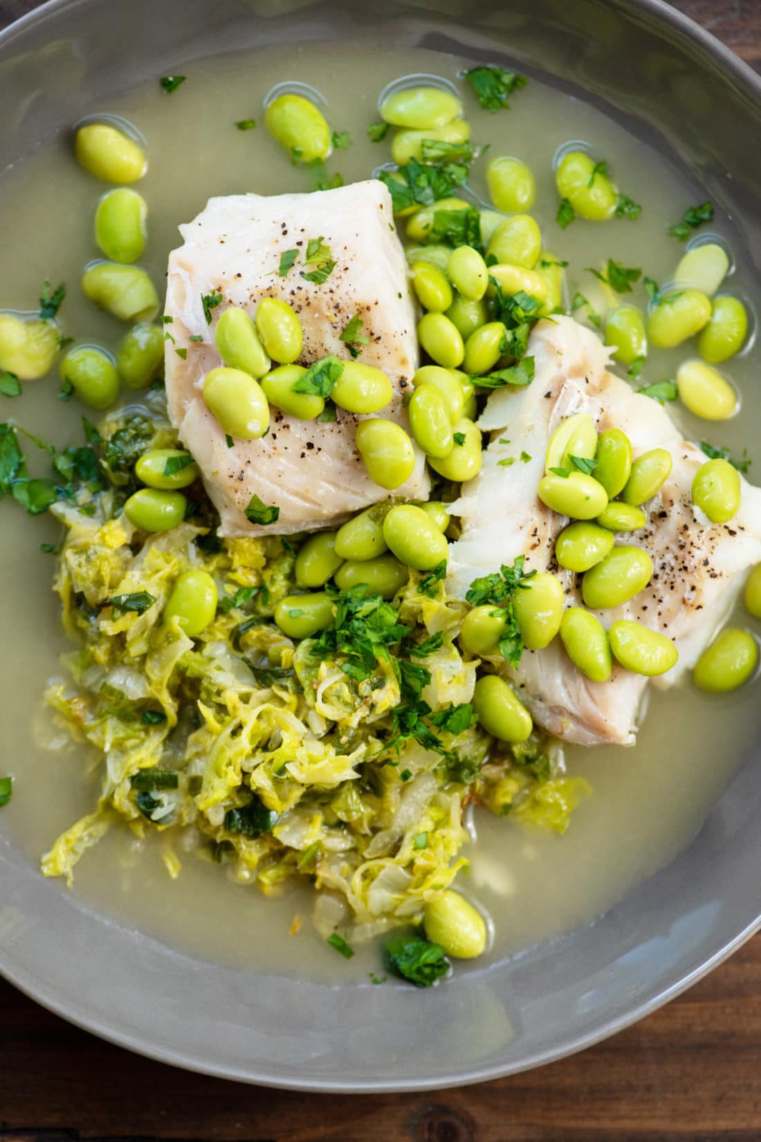 Cod served over Cabbage and topped with Edamame.