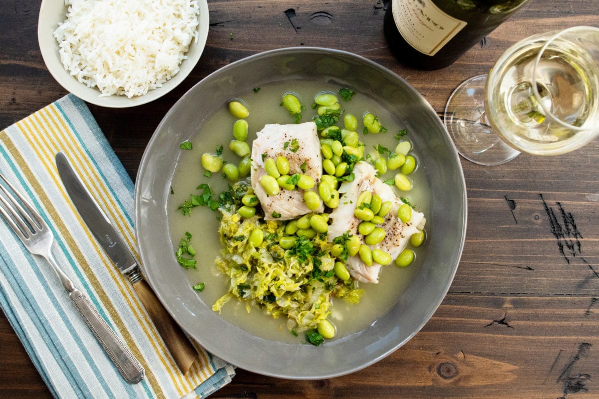 Cod, Cabbage and Edamame on a plate.