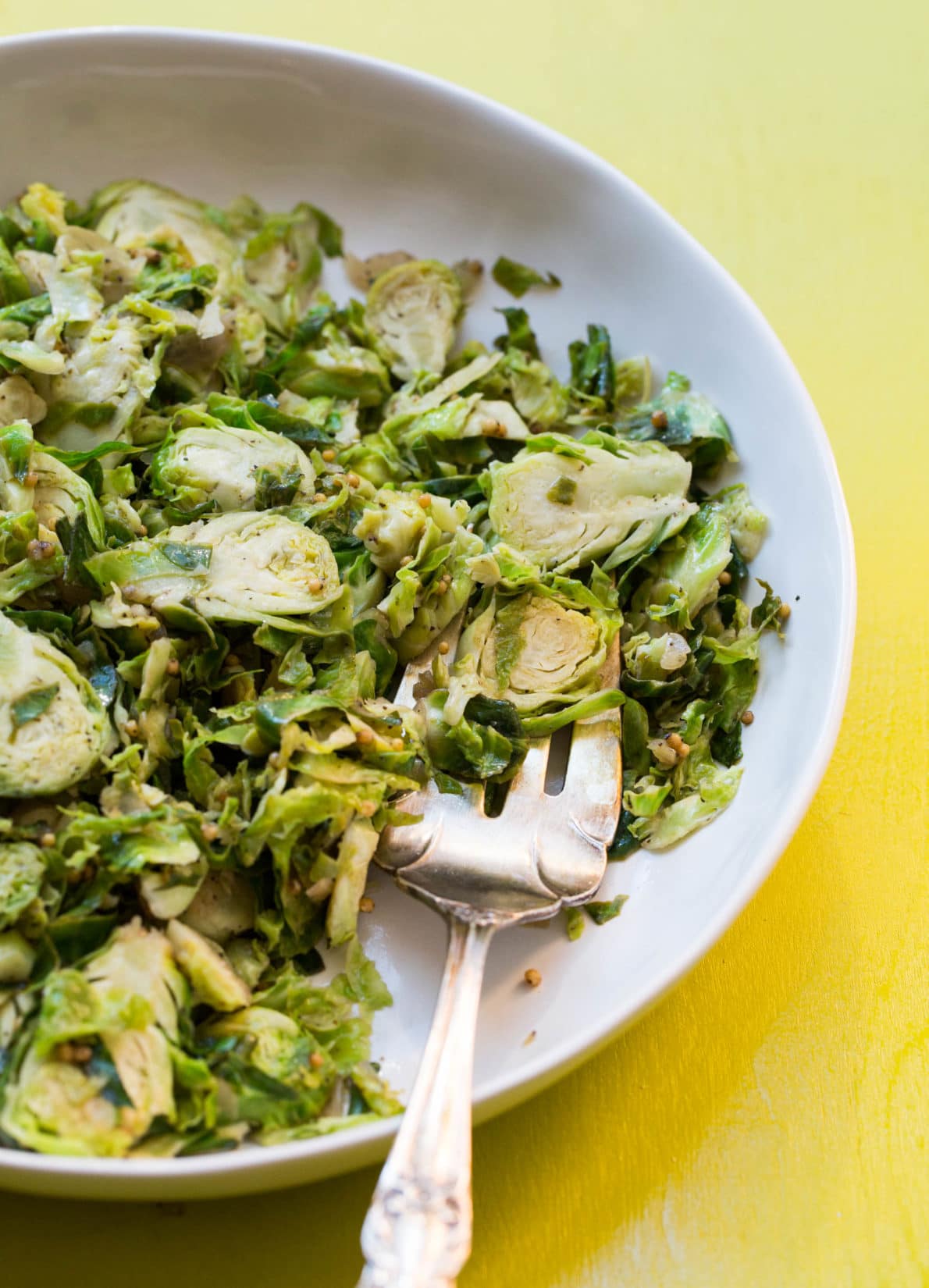 Fork in a plate of Shredded Brussel Sprouts.