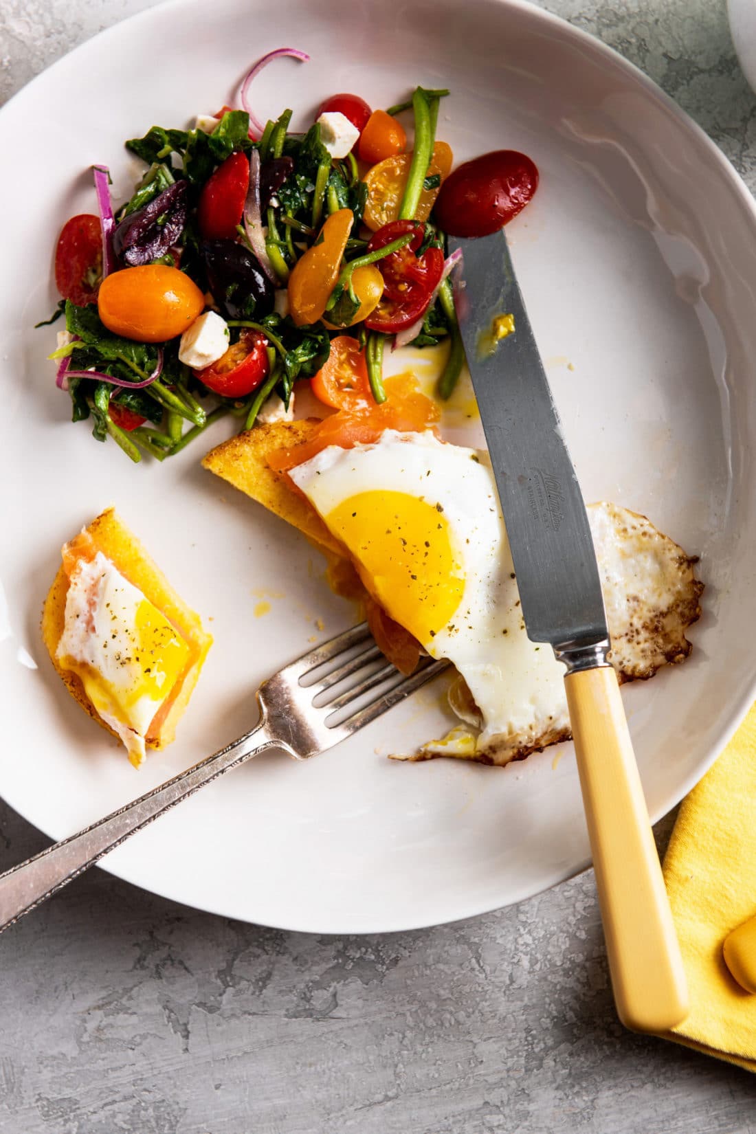 Cut up Fried Egg and Smoked Salmon over a Polenta Cake.