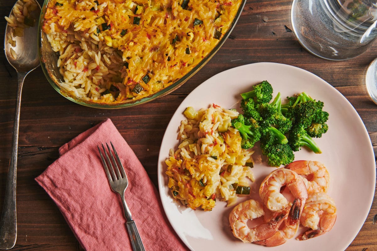 Shrimp, broccoli, and Cheesy Orzo Casserole on a plate.