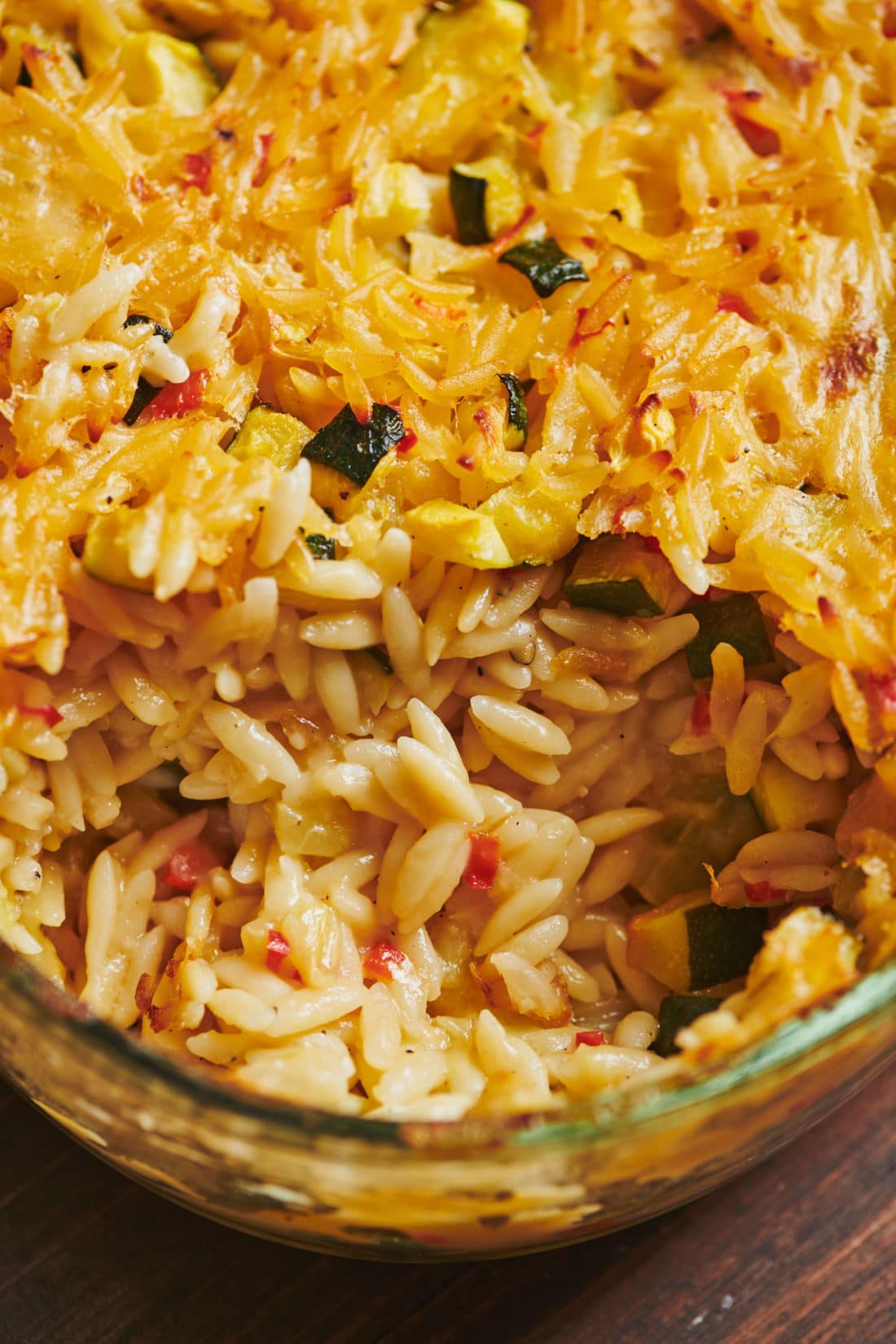 Cheesy Orzo Casserole in a glass dish.