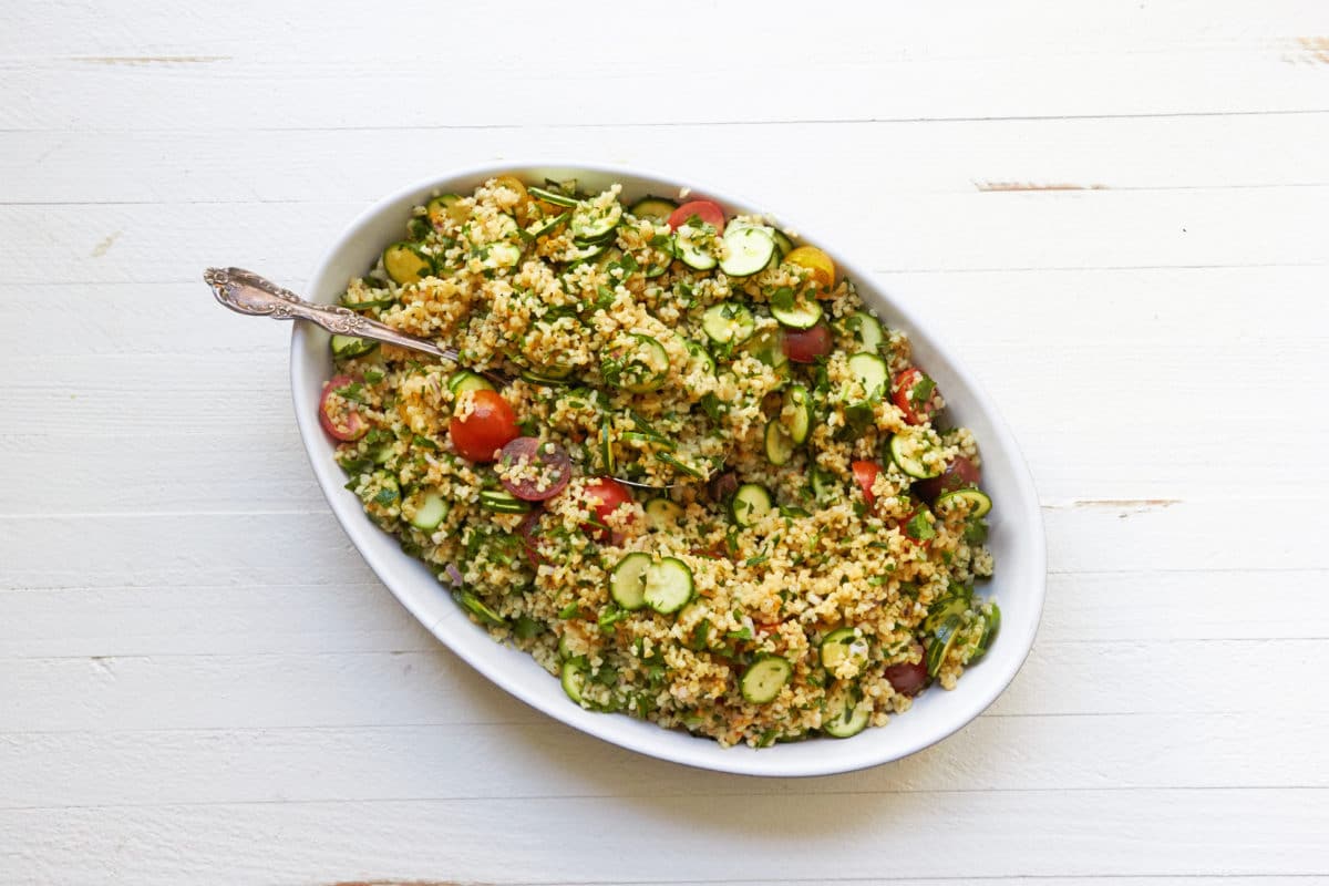 Tomato, Zucchini and Bulgur Salad in bowl with spoon.