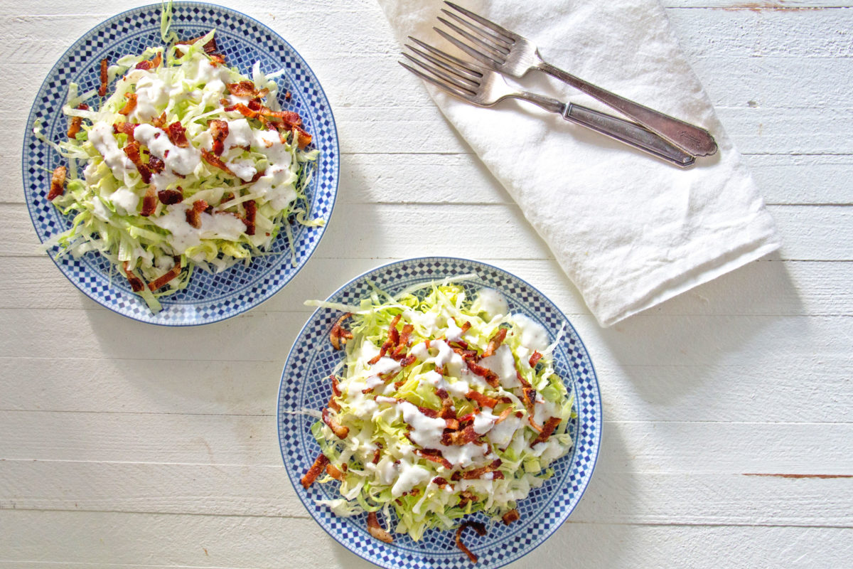 Two plates of Slivered Wedge Salad with Buttermilk Dressing and Bacon.