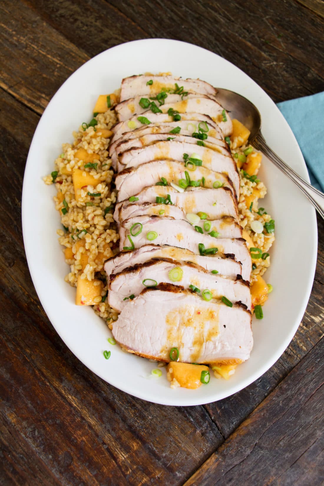 Slices of Grilled Pork Loin over Brown Rice Salad.