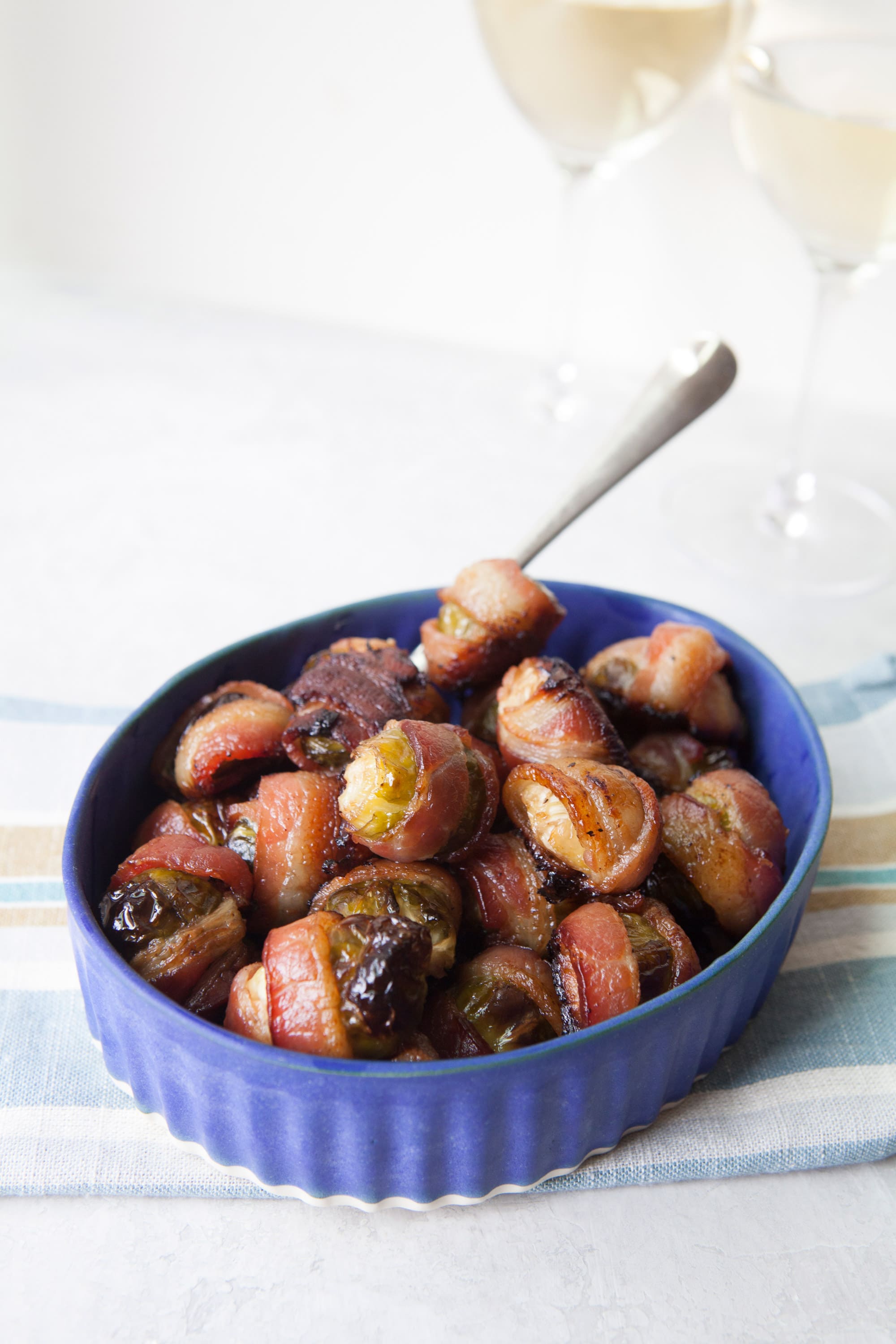 Bacon Wrapped Brussels Sprouts in a blue bowl.
