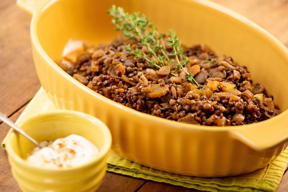 Lentils and Carrots with Dried Apricots in a yellow serving dish.
