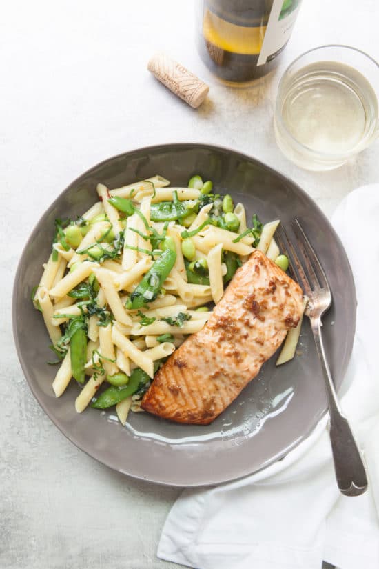 Horseradish Ginger Salmon and penne with sugar snap peas on gray plate