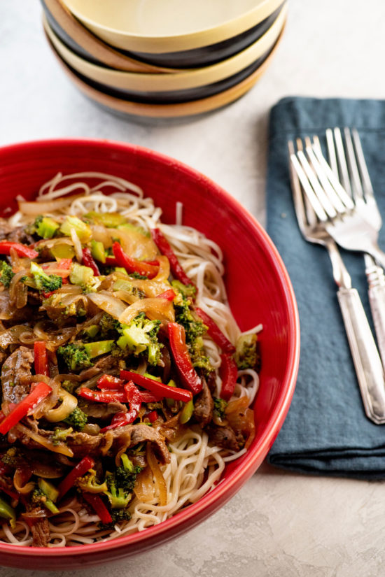 Bowl of Spicy Stir Fried Beef and Vegetables over noodles.