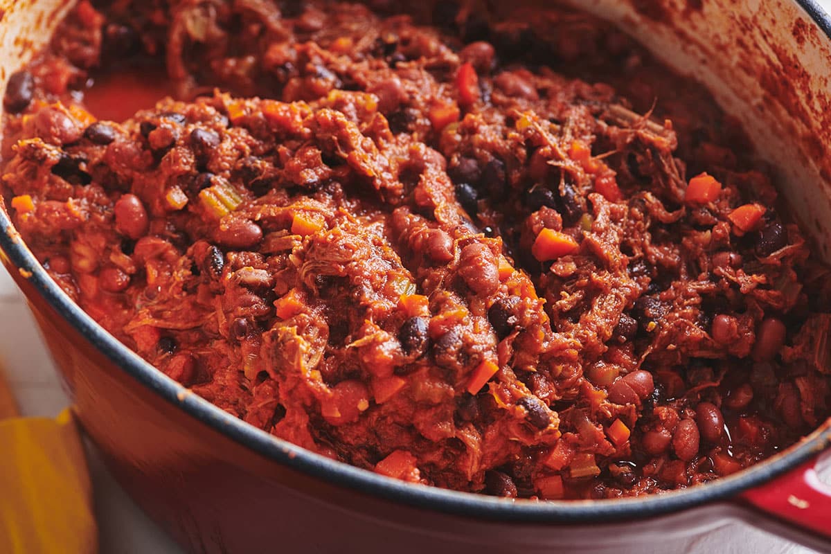 Barbacoa beef chili in red Dutch oven.