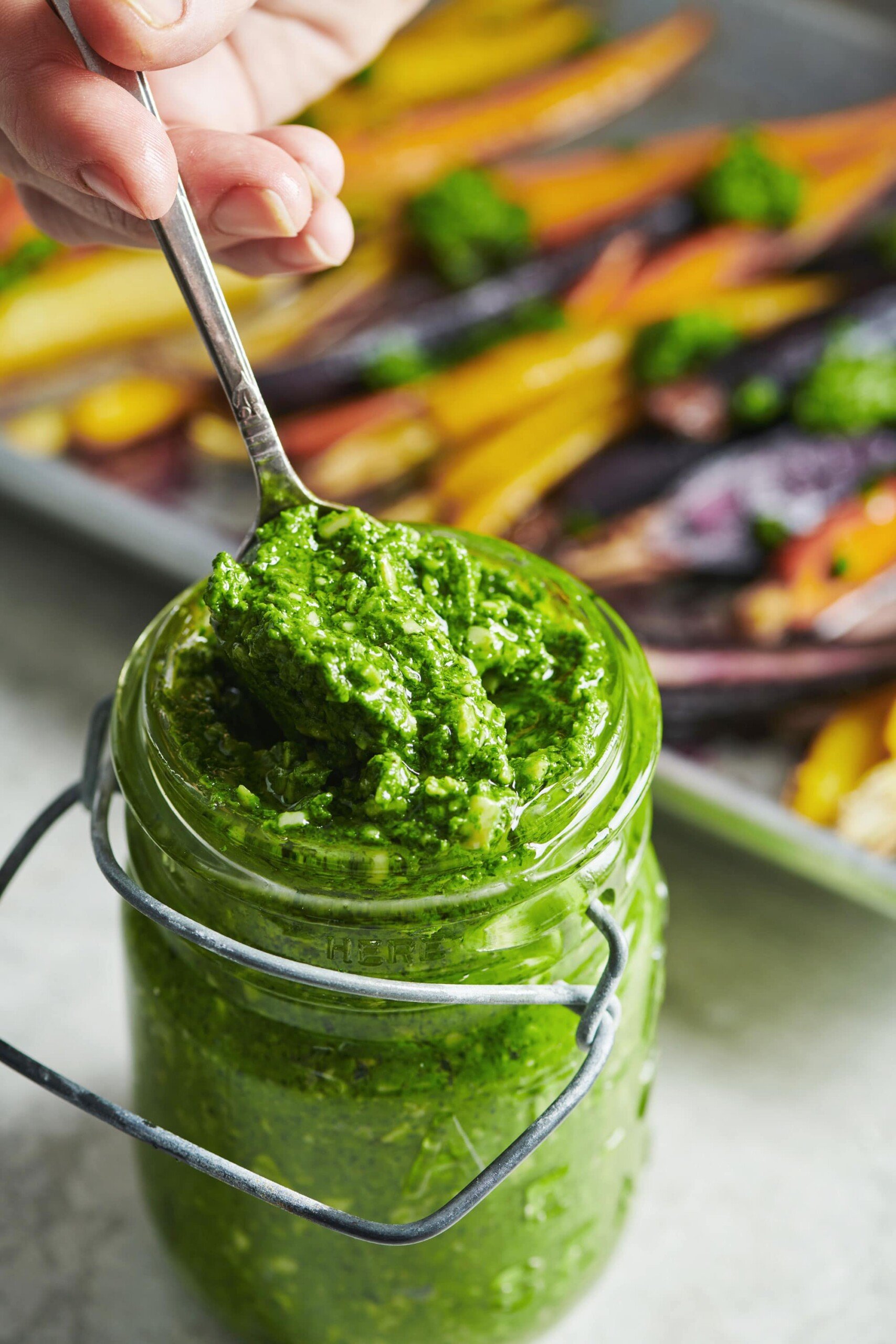Serving Spinach Parsley Pesto from glass jar.