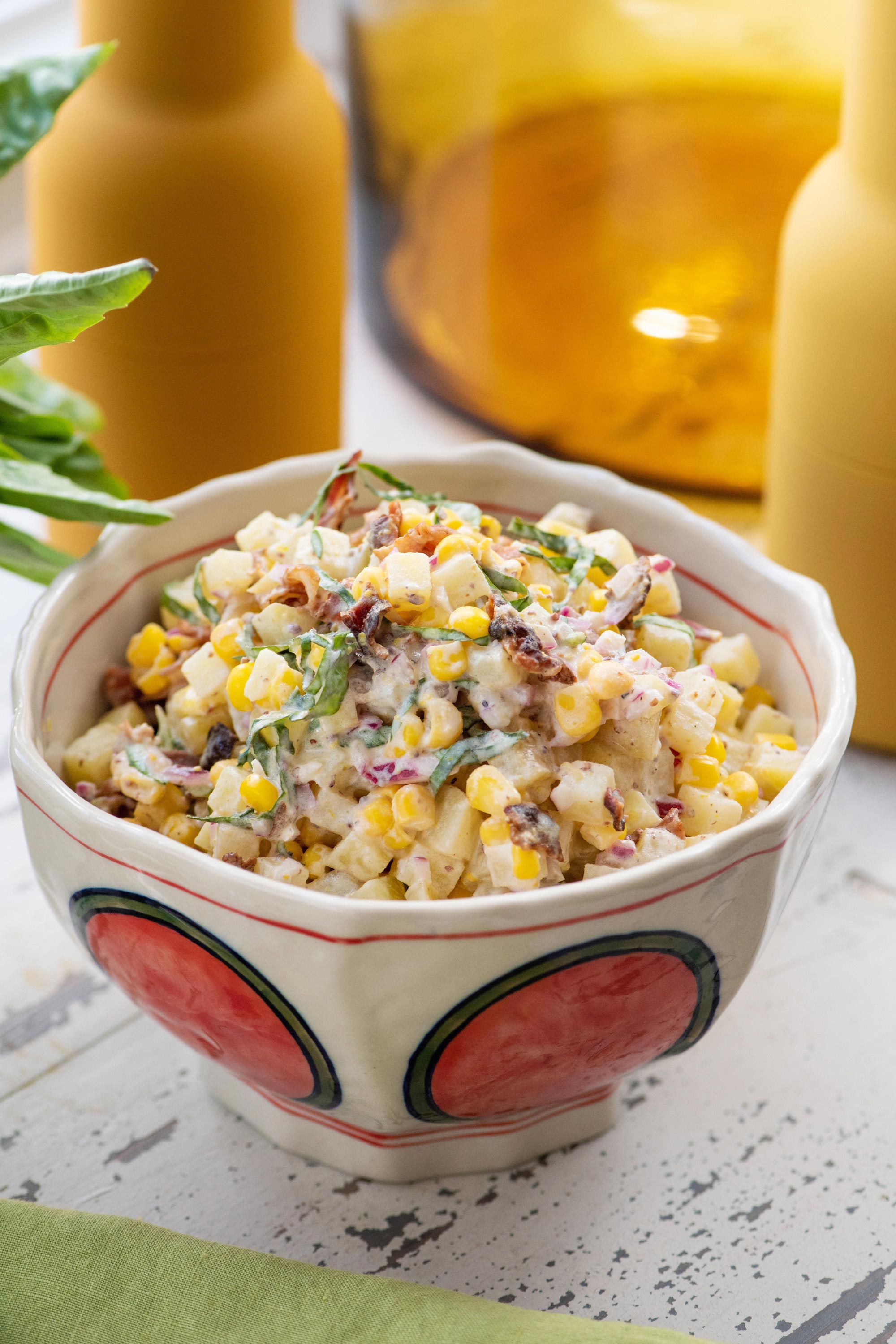 Bowl of Creamy Corn and Potato Salad with Bacon and Lemon Buttermilk Dressing.
