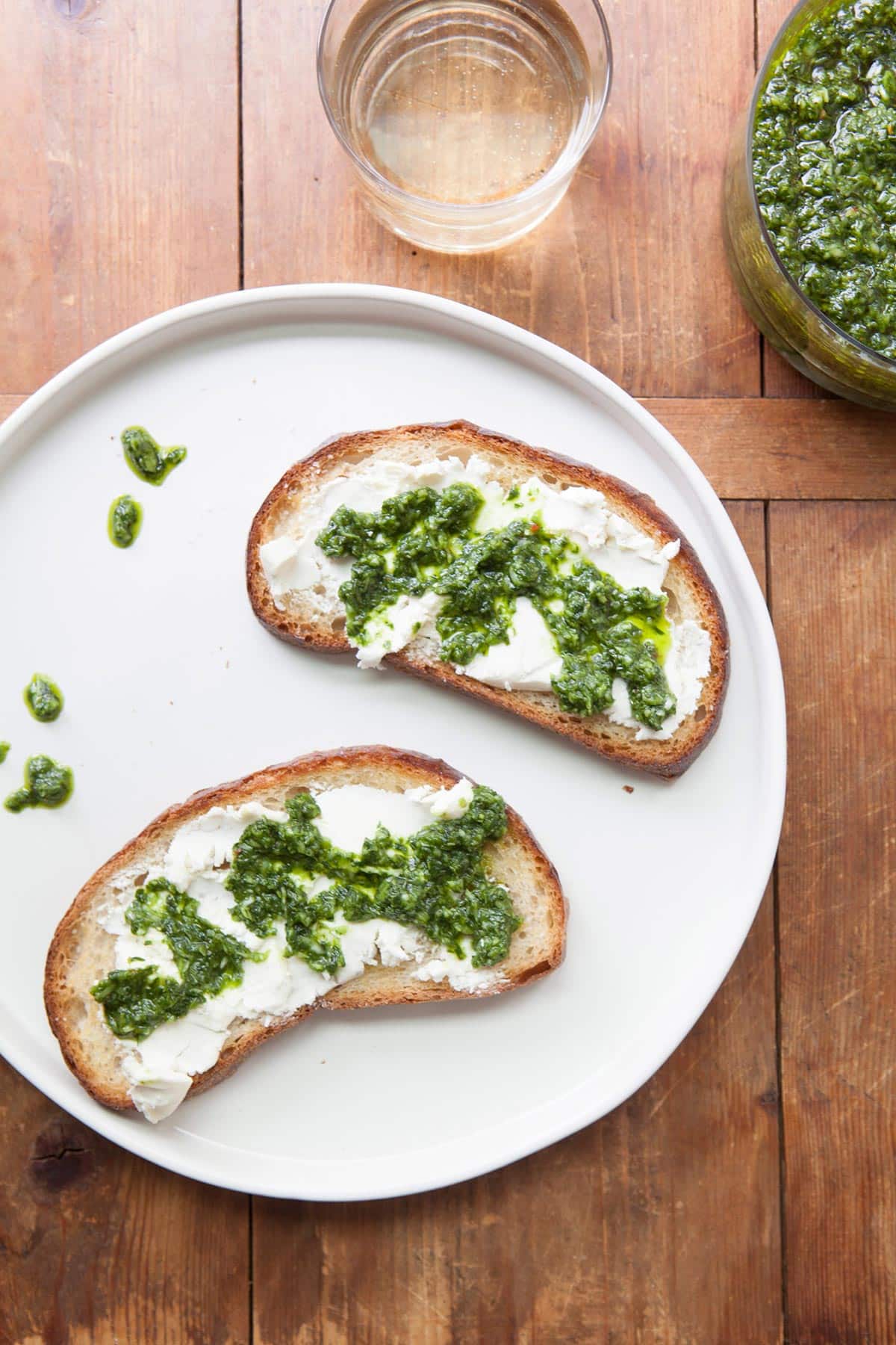 Cheese and Ramp Chimichurri Sauce crostini on a plate.